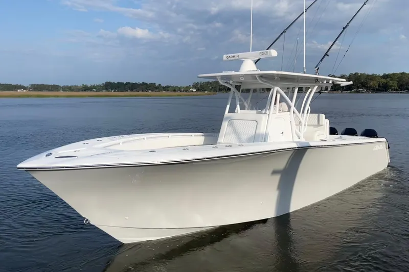  Yacht Photos Pics 2022 SeaHunter 33 Tournament boat on calm water, featuring sleek design and fishing rods.