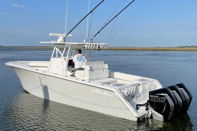 Yacht Photos Pics 2022 SeaHunter 33 Tournament boat with triple Mercury 300 engines on calm water.