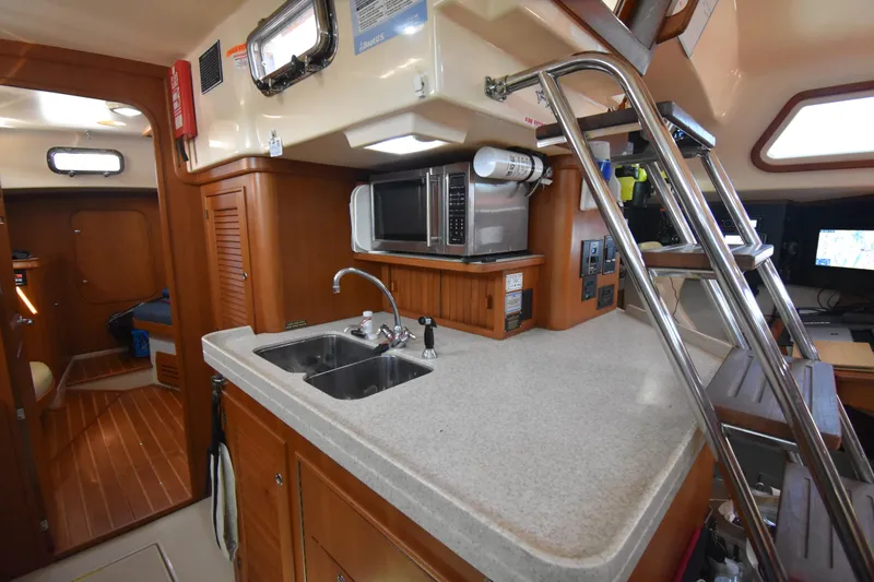 Chinook Yacht Photos Pics Interior of 2004 Island Packet 485 yacht featuring a compact kitchen area.