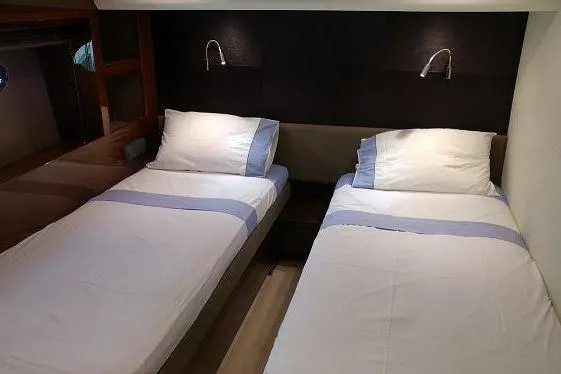  Yacht Photos Pics Twin beds in a 2014 Princess 72 yacht cabin with modern lighting.