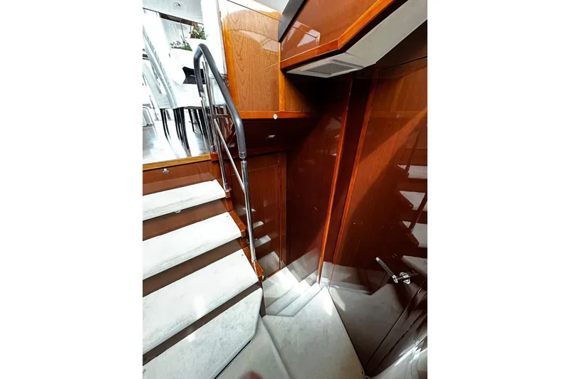  Yacht Photos Pics Luxurious interior staircase of 2014 Princess 72 yacht with polished wood finish.