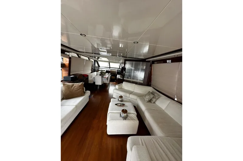  Yacht Photos Pics Luxurious interior of a 2014 Princess 72 yacht with elegant white seating and wooden flooring.