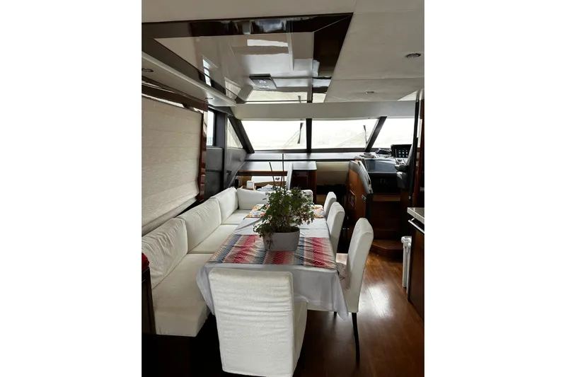  Yacht Photos Pics Luxurious interior of 2014 Princess 72 yacht with elegant dining area and panoramic windows.