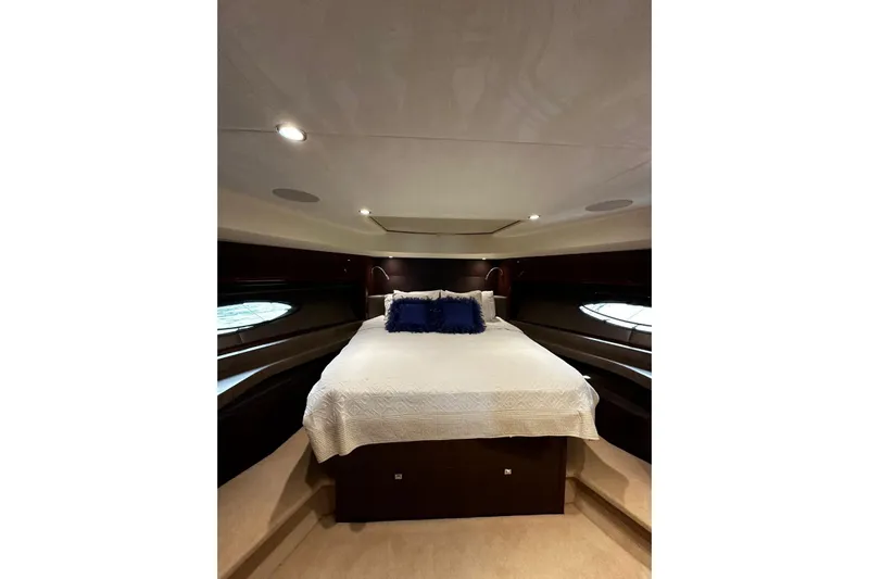  Yacht Photos Pics Luxurious bedroom interior of 2014 Princess 72 yacht with elegant bedding and ambient lighting.