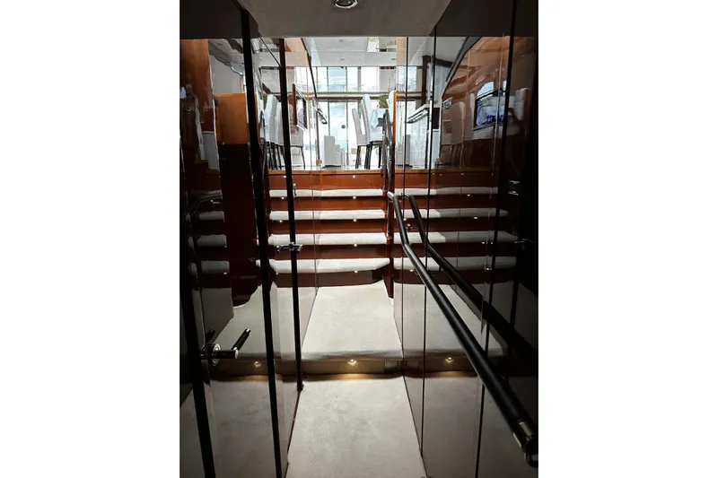  Yacht Photos Pics Interior view of 2014 Princess 72 yacht, featuring elegant stairs and glossy finishes.
