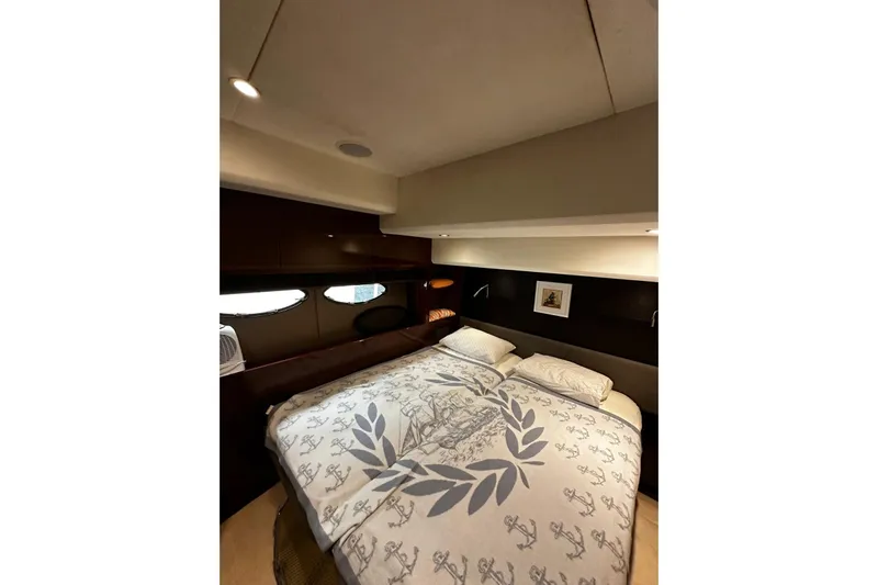  Yacht Photos Pics Luxurious bedroom interior of 2014 Princess 72 yacht with elegant bedding and ambient lighting.