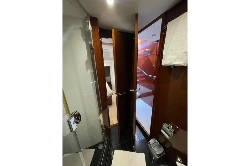  Yacht Photos Pics Luxurious bathroom interior on a 2014 Princess 72 yacht, featuring sleek wood finishes.