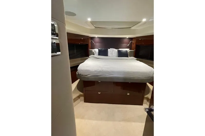  Yacht Photos Pics Luxurious bedroom interior of 2014 Princess 72 yacht with elegant bedding and ambient lighting.