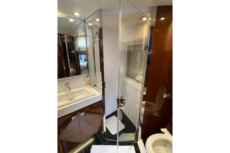  Yacht Photos Pics Luxurious bathroom in 2014 Princess 72 yacht with glass shower and modern fixtures.
