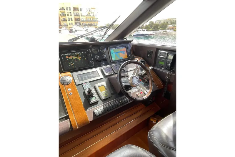  Yacht Photos Pics Cockpit of 2014 Princess 72 yacht with navigation equipment and steering wheel.