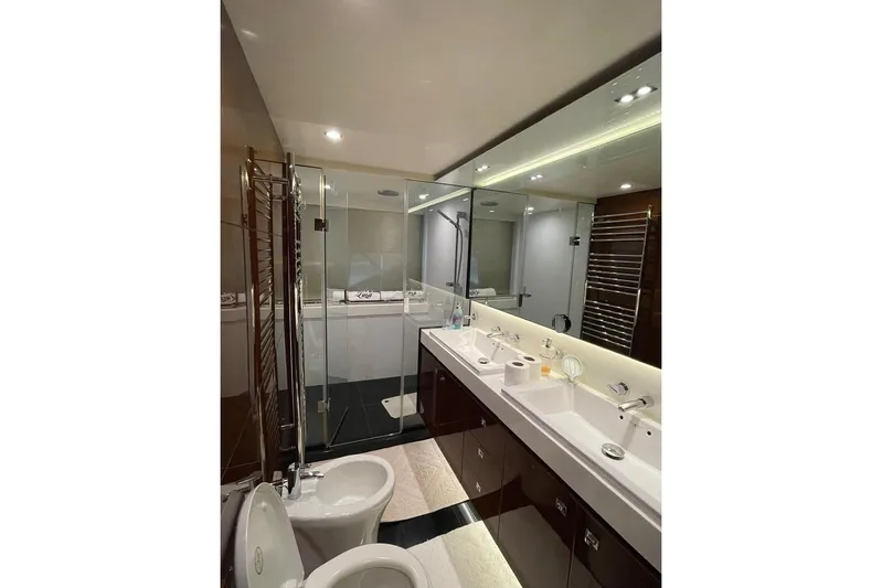  Yacht Photos Pics Luxurious bathroom in 2014 Princess 72 yacht with dual sinks and glass shower.
