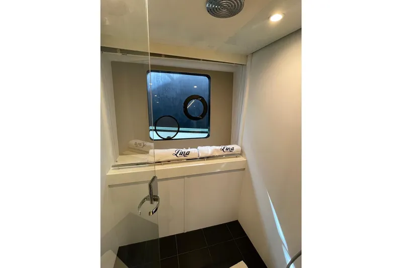  Yacht Photos Pics Luxurious bathroom in 2014 Princess 72 yacht with window and elegant fixtures.