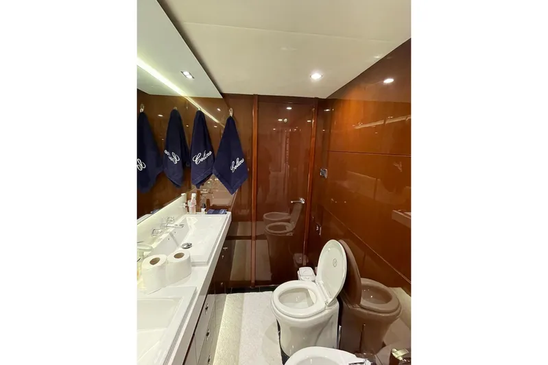  Yacht Photos Pics Luxurious bathroom in 2014 Princess 72 yacht with elegant wood paneling and modern fixtures.