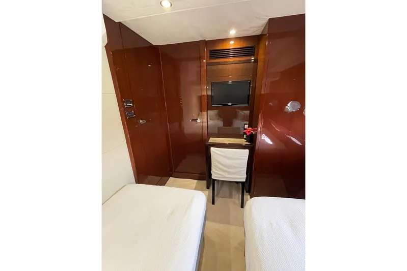  Yacht Photos Pics Luxurious cabin interior of 2014 Princess 72 yacht with twin beds and TV.
