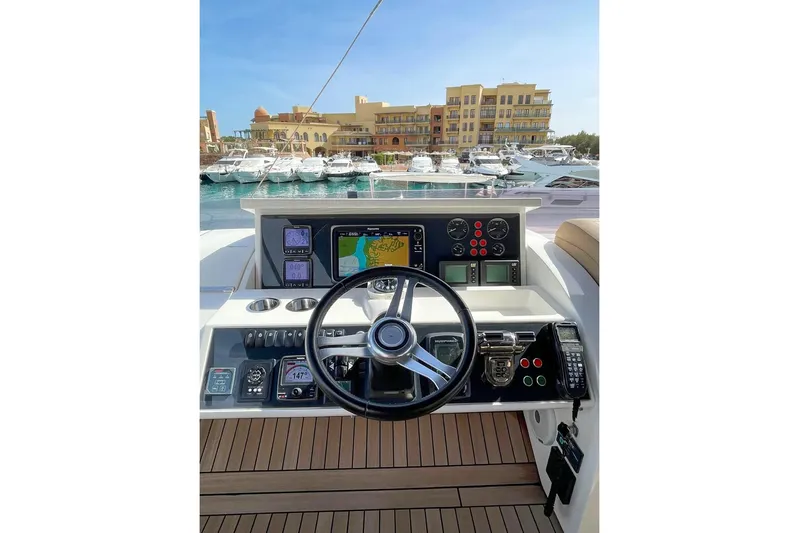  Yacht Photos Pics Cockpit of 2014 Princess 72 yacht with navigation controls and marina view.