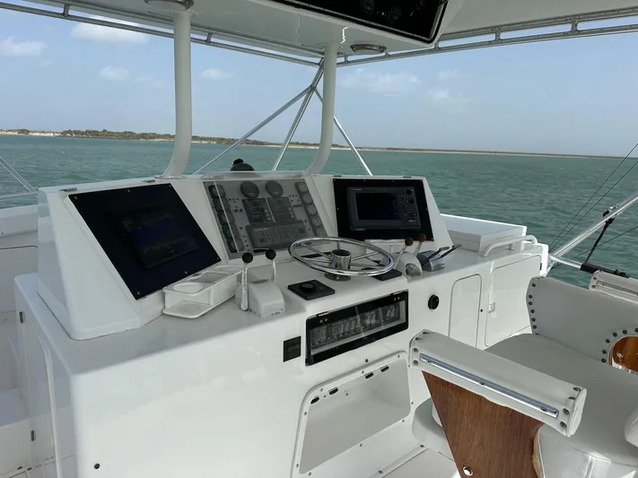  Yacht Photos Pics 1990 Bertram 50 Convertible yacht helm with navigation equipment and ocean view.