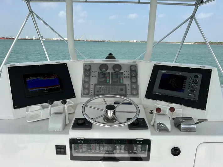  Yacht Photos Pics Control panel of a 1990 Bertram 50 Convertible yacht with navigation screens.