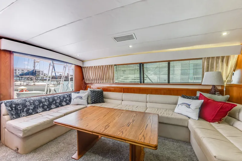  Yacht Photos Pics Luxurious interior of a 1990 Bertram 50 Convertible yacht with plush seating and wooden table.