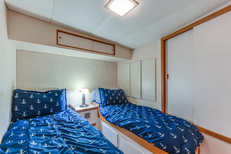  Yacht Photos Pics Cozy twin cabin with nautical bedding on 1990 Bertram 50 Convertible yacht.