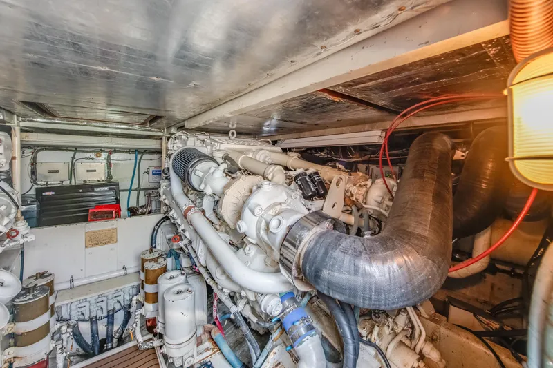  Yacht Photos Pics Engine room of 1990 Bertram 50 Convertible yacht, showcasing complex machinery and components.