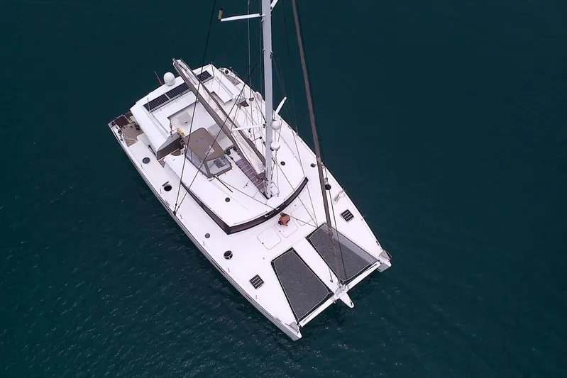 Sea Jade Yacht Photos Pics Aerial view of 2014 FONTAINE PAJOT 63 catamaran sailing on calm waters.