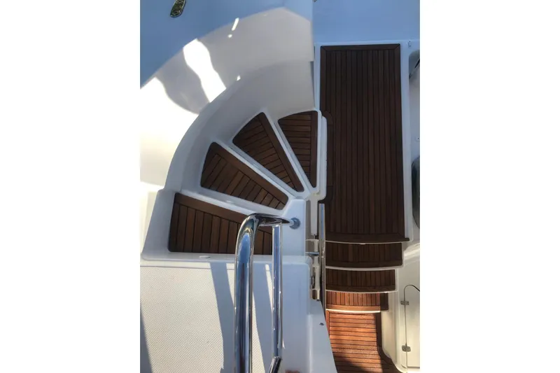 Sea Jade Yacht Photos Pics Staircase on 2014 FONTAINE PAJOT 63 yacht with wooden steps and metal railing.