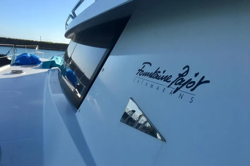 Sea Jade Yacht Photos Pics 2014 FONTAINE PAJOT 63 catamaran, sleek design, docked by the water.