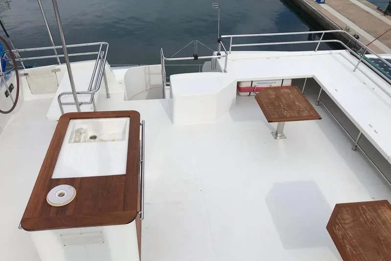 Sea Jade Yacht Photos Pics Spacious deck of 2014 FONTAINE PAJOT 63 yacht with wooden tables and sink.