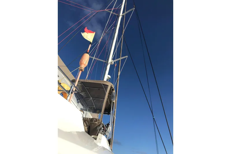 Sea Jade Yacht Photos Pics Sailboat mast and rigging of 2014 FONTAINE PAJOT 63 against clear blue sky.