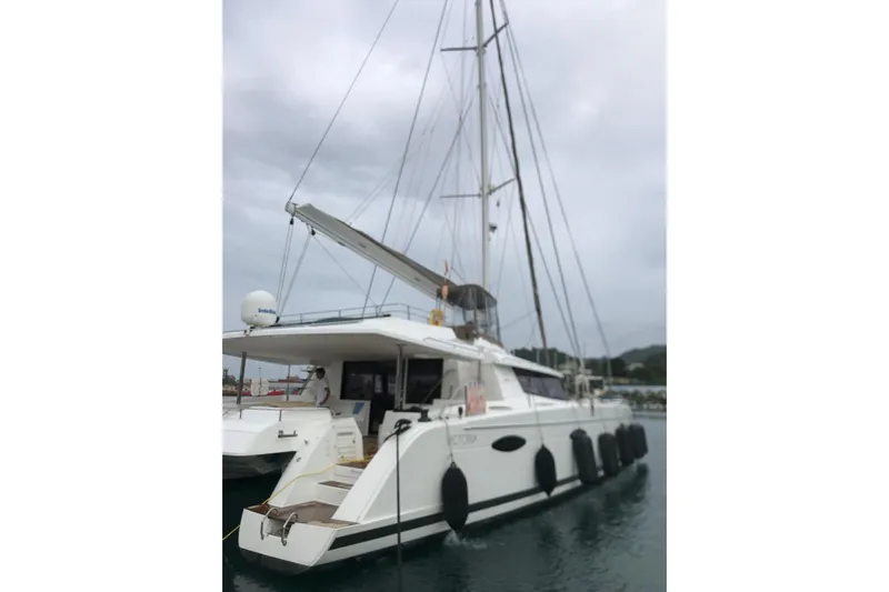 Sea Jade Yacht Photos Pics 2014 FONTAINE PAJOT 63 catamaran docked in a marina under cloudy skies.