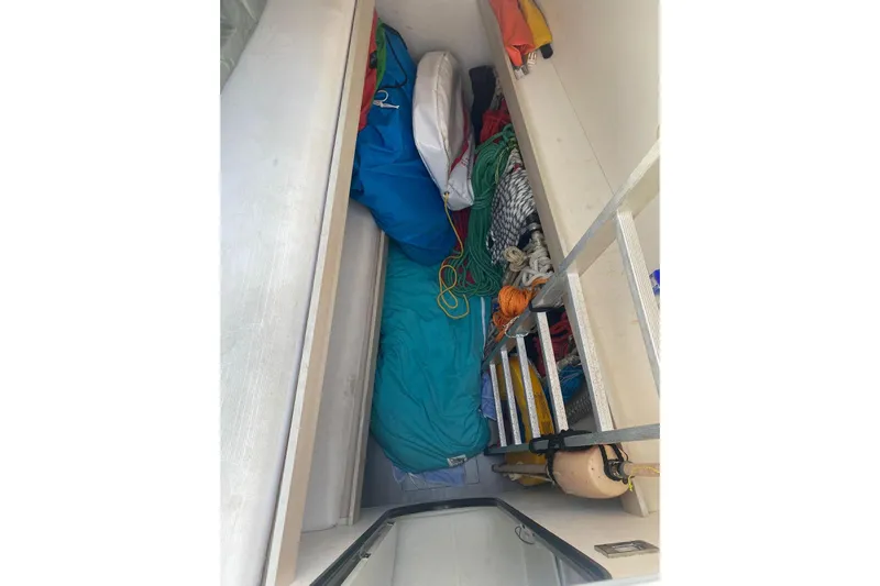 Sea Jade Yacht Photos Pics Storage compartment on a 2014 FONTAINE PAJOT 63 yacht, filled with ropes and equipment.