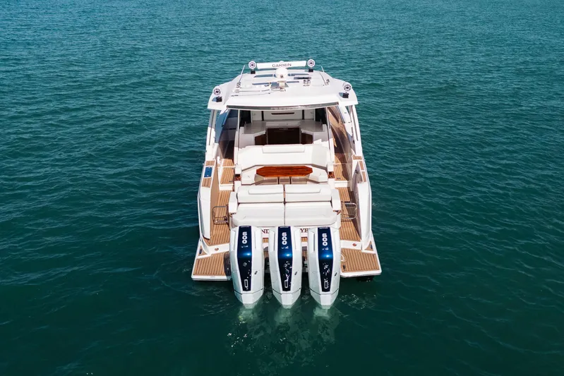 Phoenix Yacht Photos Pics 2023 Tiara 48 yacht with triple outboard engines on open water.