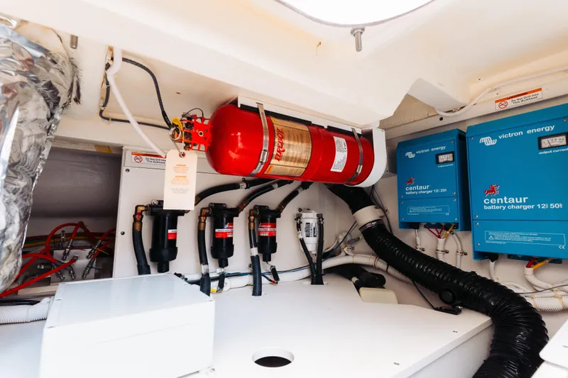 Phoenix Yacht Photos Pics Engine room of 2023 Tiara 48 yacht with fire extinguisher and battery chargers.