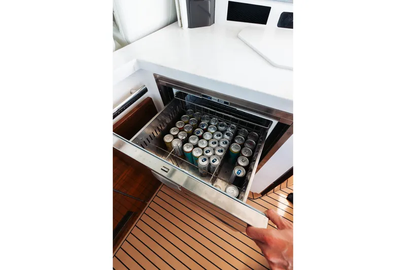 Phoenix Yacht Photos Pics Open drawer fridge with canned drinks on Tiara 48 yacht, 2023 model.