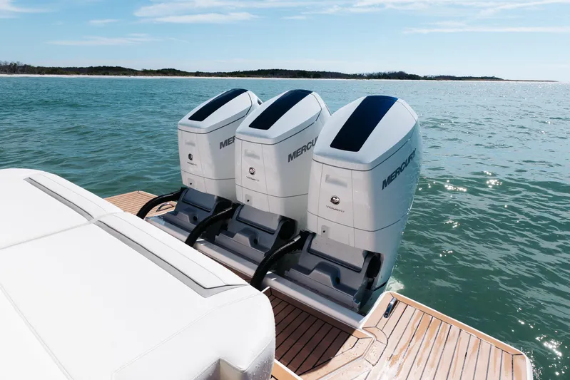 Phoenix Yacht Photos Pics 2023 Tiara 48 boat with triple Mercury outboard engines on open water.