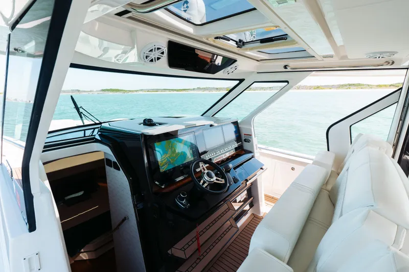 Phoenix Yacht Photos Pics 2023 Tiara 48 yacht interior with modern helm and panoramic ocean view.