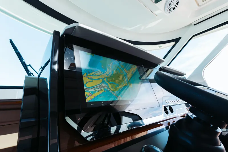 Phoenix Yacht Photos Pics Dashboard of 2023 Tiara 48 yacht with navigation screen and steering wheel.