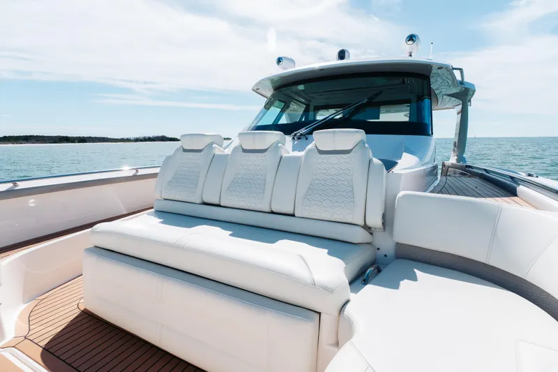 Phoenix Yacht Photos Pics Luxurious 2023 Tiara 48 yacht with elegant white seating on a sunny day at sea.