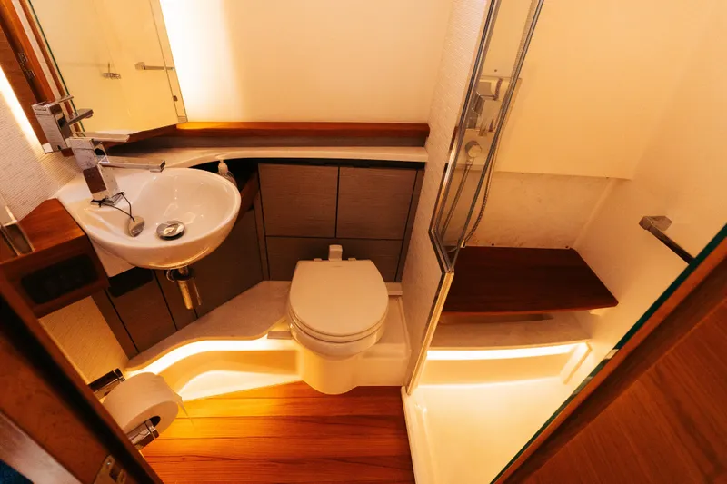 Phoenix Yacht Photos Pics Luxurious bathroom in 2023 Tiara 48 yacht with modern fixtures and elegant lighting.