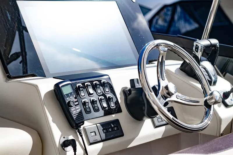 Syren Yacht Photos Pics 2022 Regal 42 FXO boat helm with steering wheel and control panel.