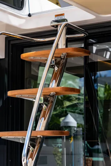 Syren Yacht Photos Pics Stainless steel and wood spiral staircase on 2022 Regal 42 FXO yacht.