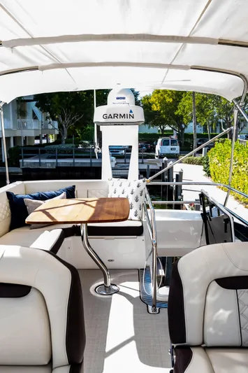 Syren Yacht Photos Pics 2022 Regal 42 FXO yacht interior with seating and Garmin navigation system.