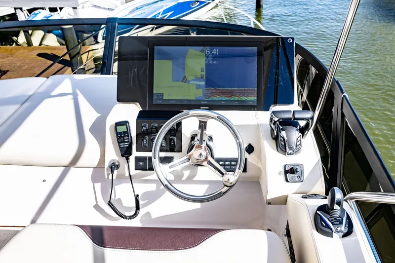 Syren Yacht Photos Pics 2022 Regal 42 FXO boat helm with navigation display and controls.