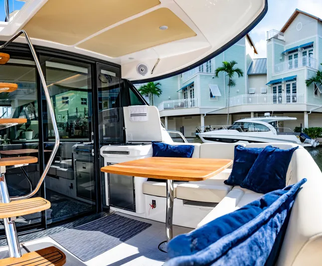 Syren Yacht Photos Pics Luxurious 2022 Regal 42 FXO yacht interior with plush seating and elegant design.