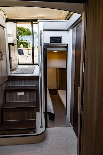 Syren Yacht Photos Pics Interior of 2022 Regal 42 FXO yacht, featuring modern stairs and cozy cabin space.