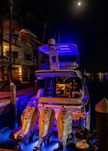 Syren Yacht Photos Pics 2022 Regal 42 FXO yacht illuminated at night with blue lights.