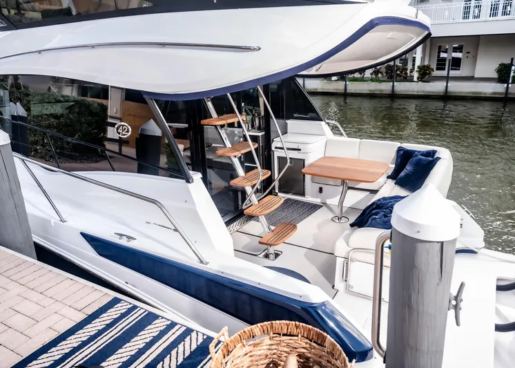 Syren Yacht Photos Pics 2022 Regal 42 FXO luxury yacht docked, featuring elegant seating and modern design.