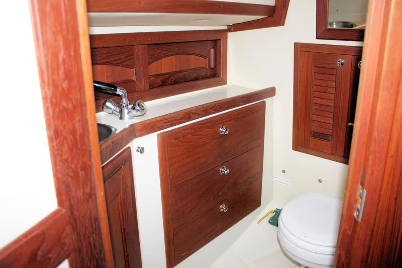 Tigerlily Yacht Photos Pics Interior of 2004 Pacific Seacraft 31 sailboat bathroom with wooden cabinetry and fixtures.