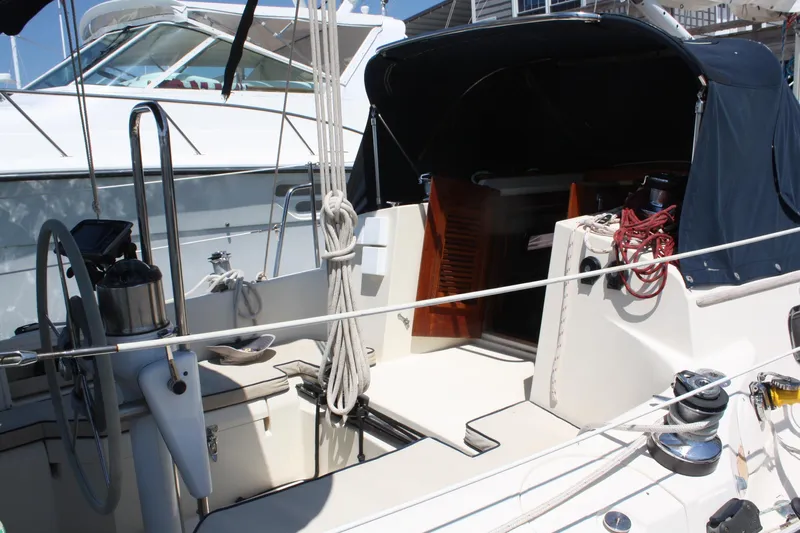 Tigerlily Yacht Photos Pics 2004 Pacific Seacraft 31 sailboat cockpit with steering wheel and ropes.