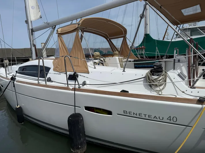 Deep Unreal Yacht Photos Pics 2008 Beneteau Oceanis 40 sailboat docked, featuring beige canopy and sleek design.